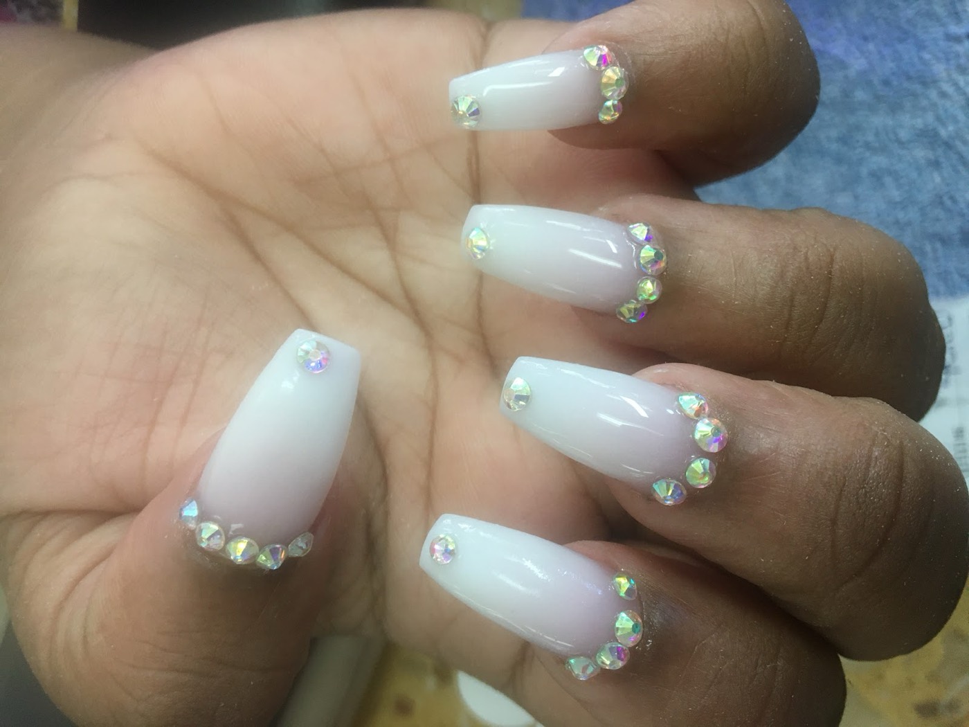 Milky French-ombré coffin nails edged with tiny crystals