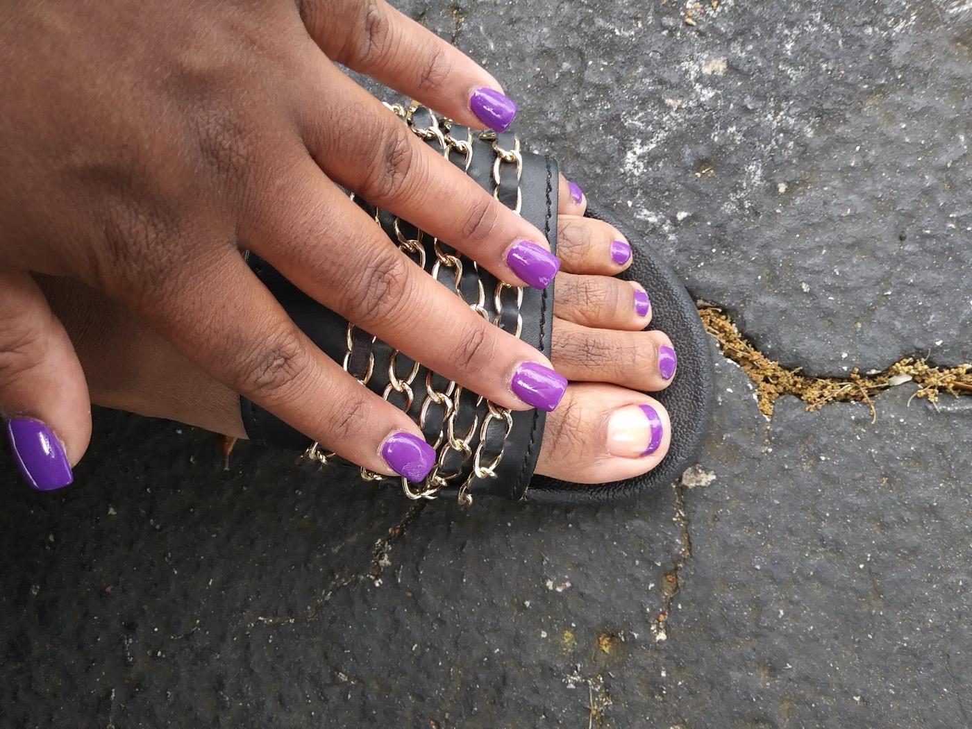 Matching purple manicure and pedicure in a glossy finish