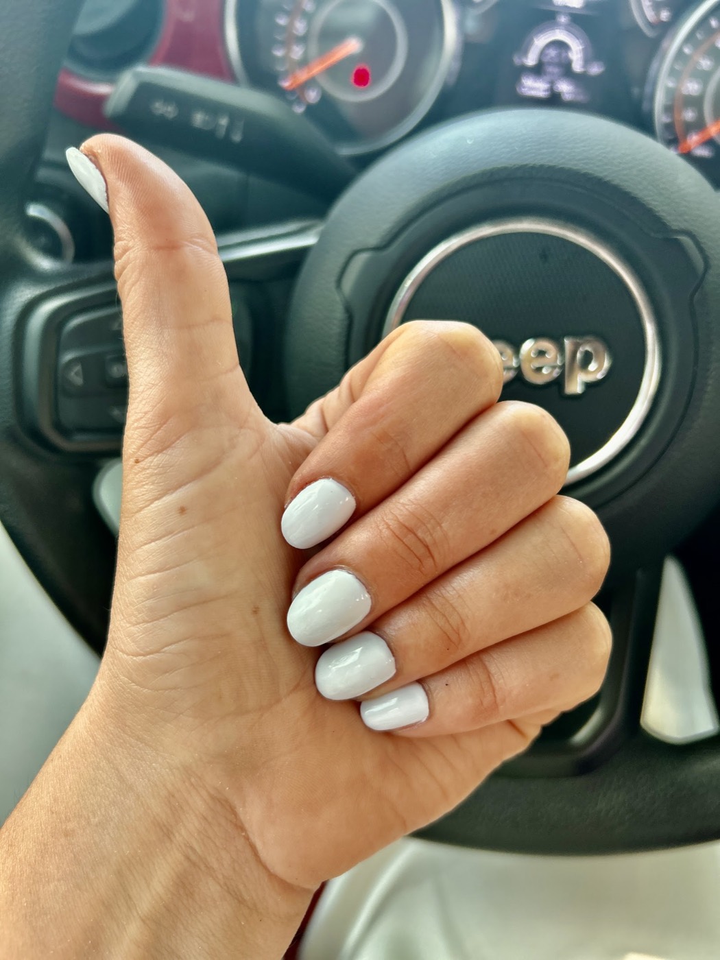 Short squoval nails in a clean glossy white